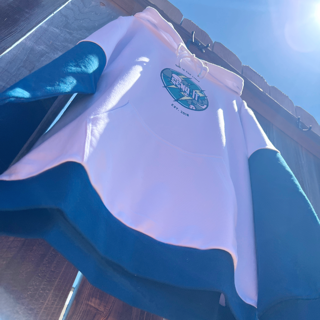 White and blue shirt with a logo on a wooden surface
