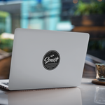 Laptop with a sticker on a table in a blurred indoor setting